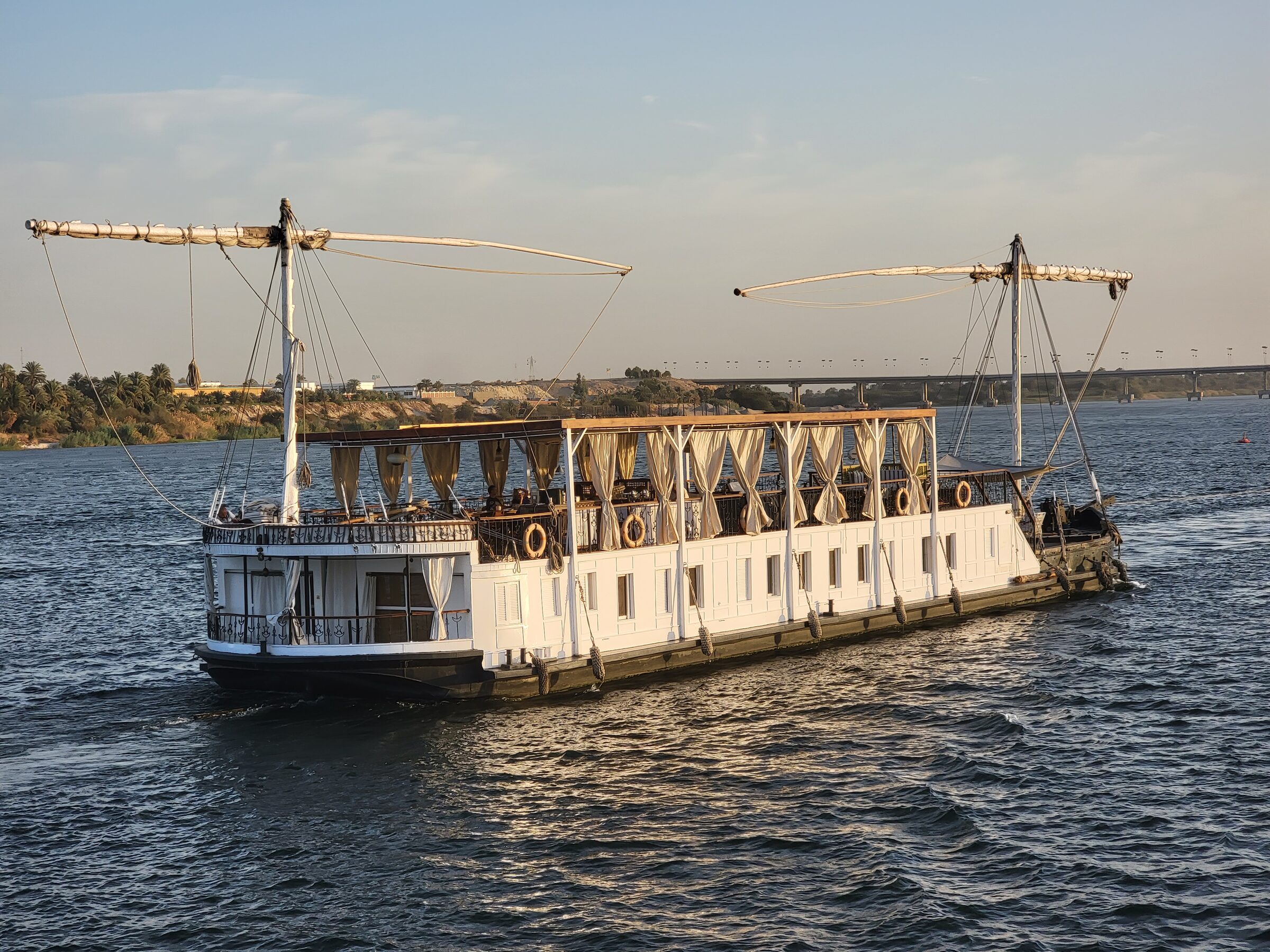 The lateen sail of a dahabiya against the Nile sky