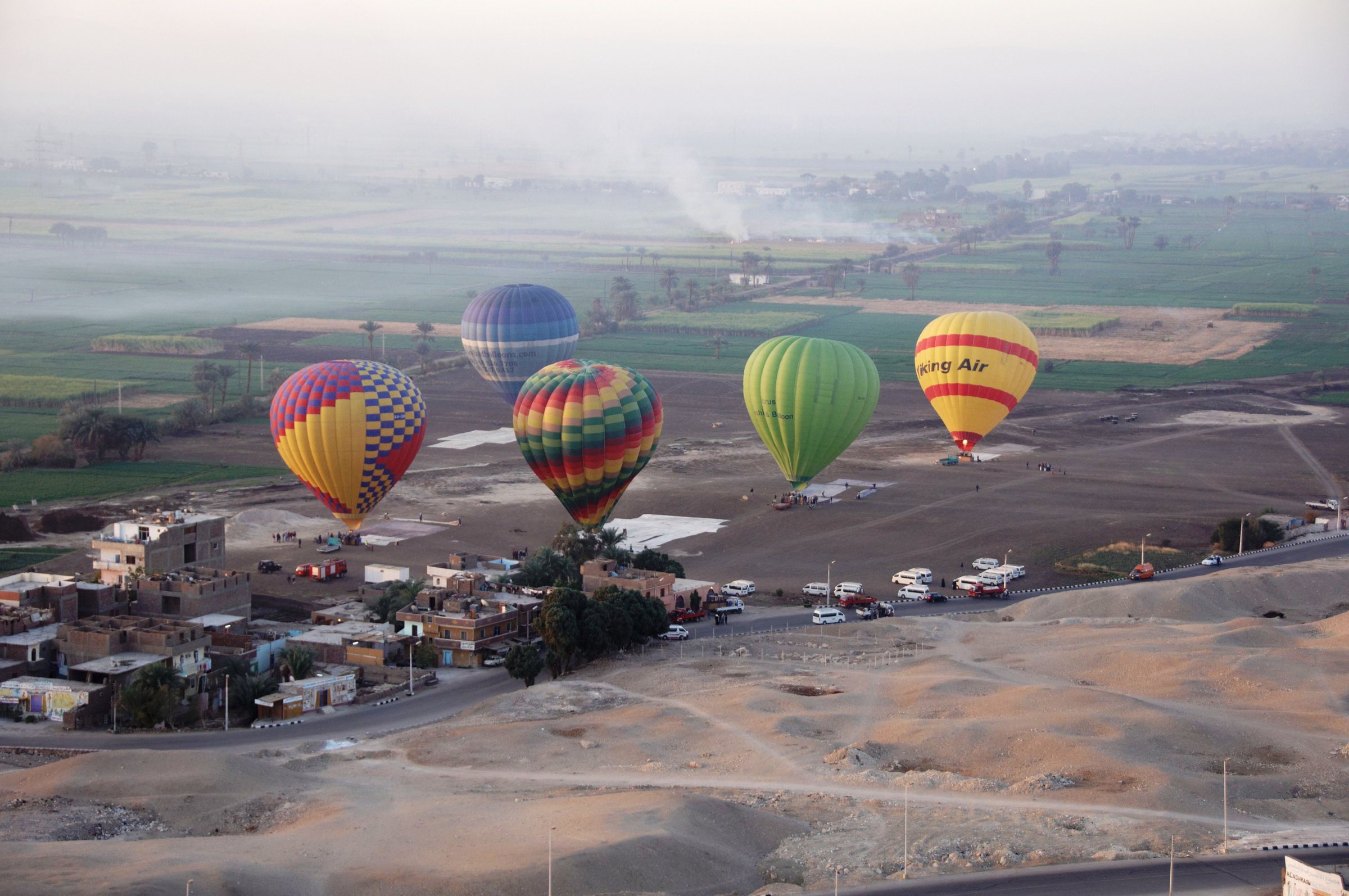 Hot-air balloons drifting over the fields and villages of Luxor's West Bank