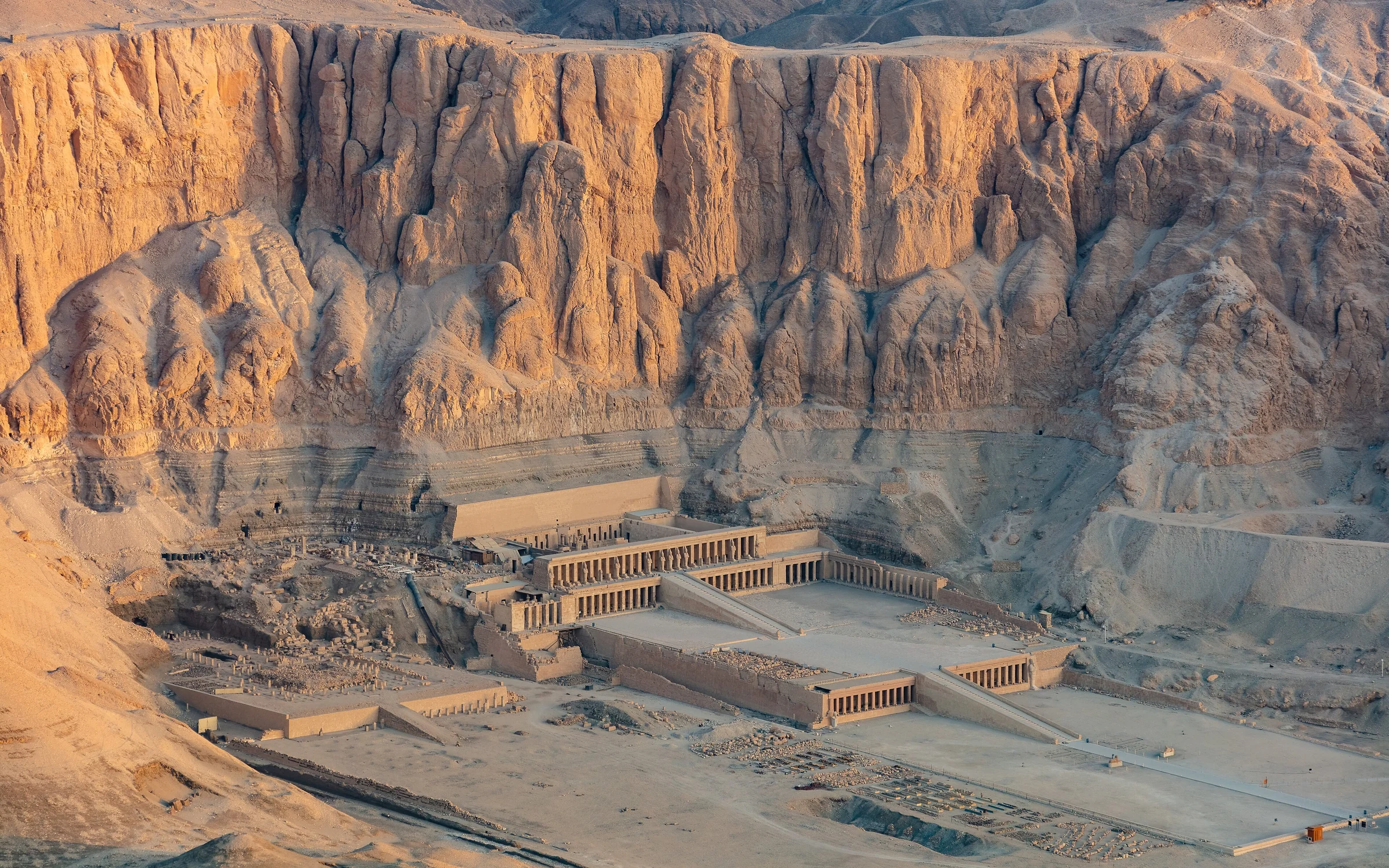 The terraces of Hatshepsut’s temple beneath the Theban cliffs in warm light